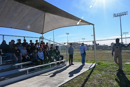 Staff Sgt. Tariq Russell, 802nd Security Forces Squadron military working dog handler, narrates a MWD demonstration to 29 Junior Reserve Officer Training Corps students from the Thomas C. Clark High School at Joint Base San Antonio- Medina Annex, Texas, Jan. 12, 2024.