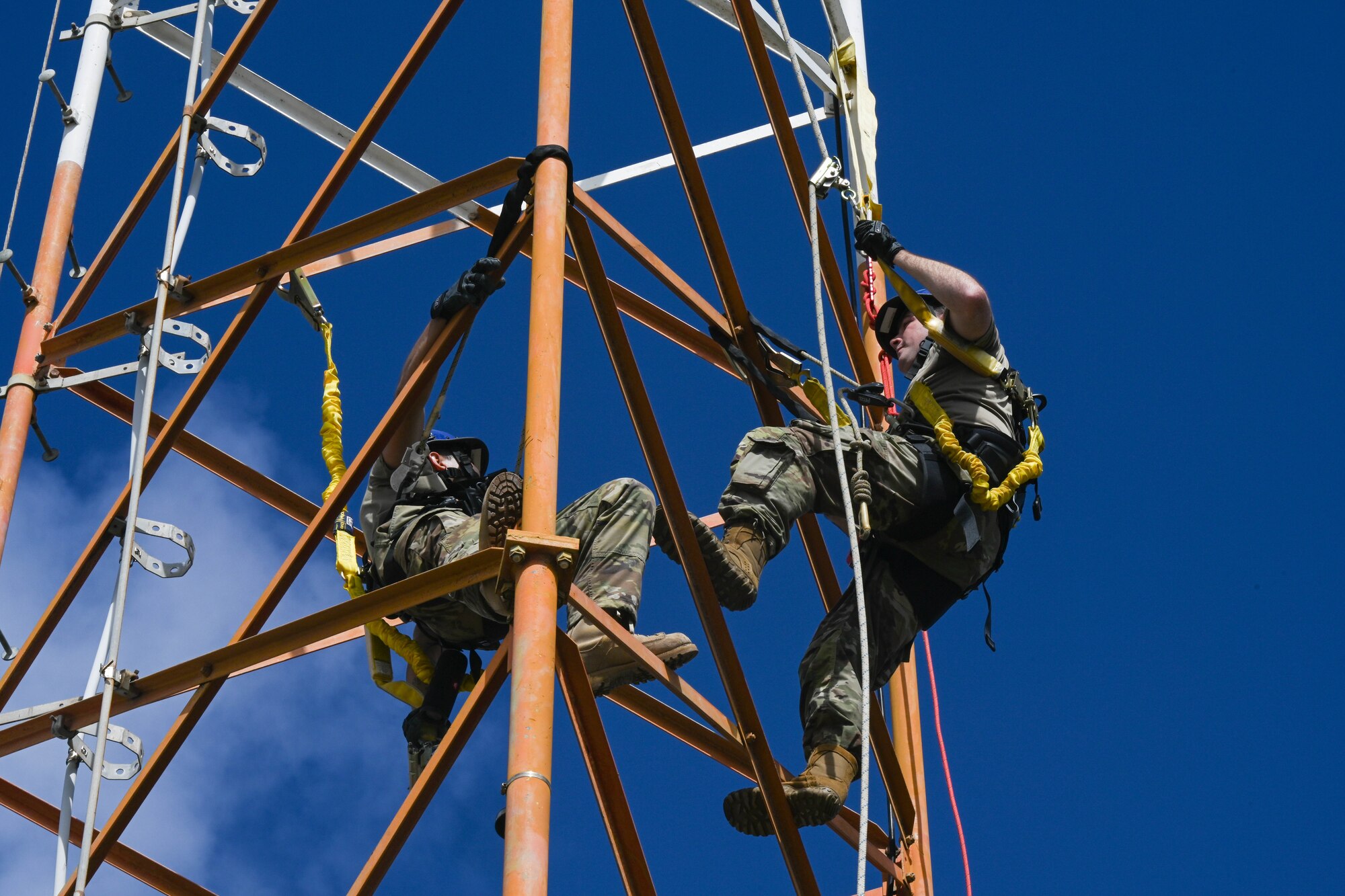Staff Sgt. James Fearney, and Senior Airman Samuel Nix, 747th Cyber Security Squadron expeditionary communications specialists, complete a climbing certification class at Joint Base Pearl Harbor-Hickam, Hawaii, Jan. 11, 2024. Cyber airmen conduct routine maintenance to the towers supporting the Joint Base and are responsible for keeping the Internet and phone communications running. (U.S. Air Force photo by Senior Airman Makensie Cooper)
