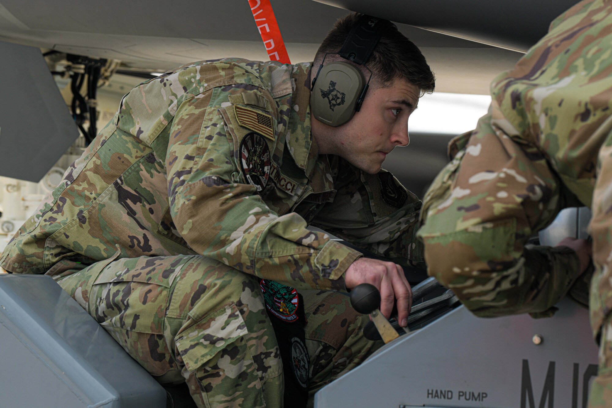 airman loads munitions underneath F-35A Lightning 11