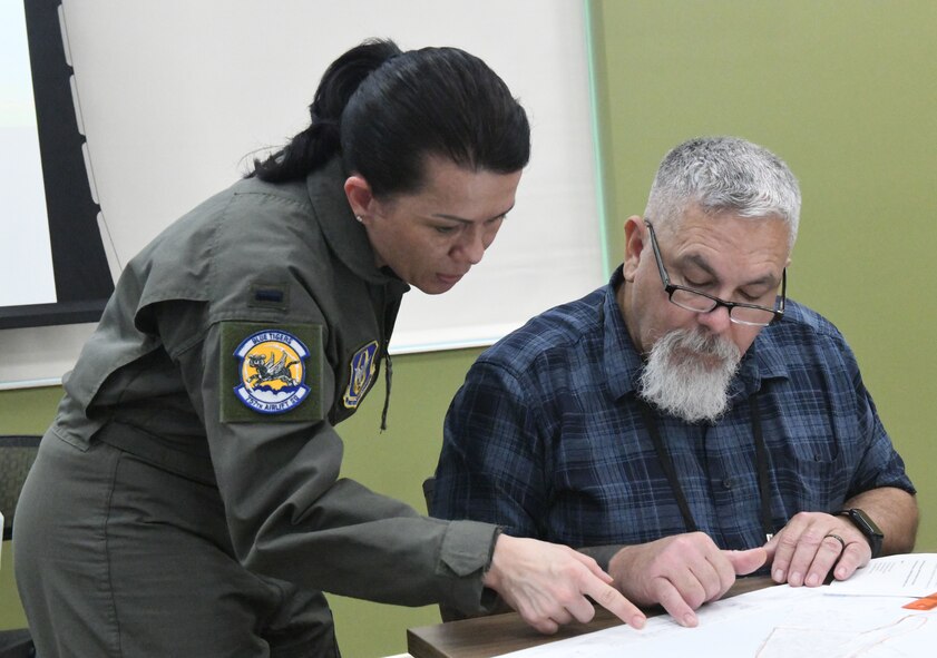 First Lt. Bethany Eutsey, a medical entomologist assigned to the 757th Airlift Squadron, assists a course attendee with mapping in preparation for the aerial spray demonstration as part of the Department of Defense Aerial Spray Category 11 Applicator Course at Manatee County Mosquito Control District’s Headquarters, Florida, from Jan. 8-11, 2024.