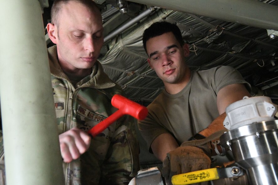 Tech. Sgt. Patrick Sherman and Staff Sgt. Bryce Cooper, aerial spray technicians assigned to the 757th Airlift Squadron, ready the 910th Airlift Wing’s modular spray system, Jan. 7, 2024, for a C-130H Hercules aerial spray demonstration at the Manatee County Regional Airport, Florida.