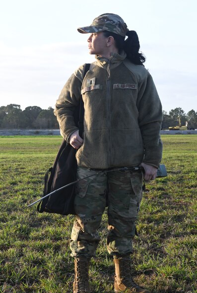 First Lt. Bethany Eutsey, medical entomologist assigned to the 757th Airlift Squadron, surveys the area prior to an aerial spray demonstration, Jan. 10, 2024, at the Manatee County Regional Airport, Florida.