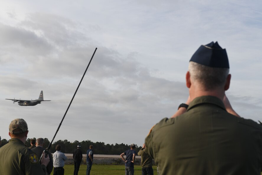 Col. Michael Maloney, 910th Airlift Wing commander, watches as a 910th Airlift Wing aerial spray modified C-130H Hercules sprays water from its training modular aerial spray system during an aerial spray demonstration, Jan. 10, 2024, at the Manatee County Regional Airport, Florida.