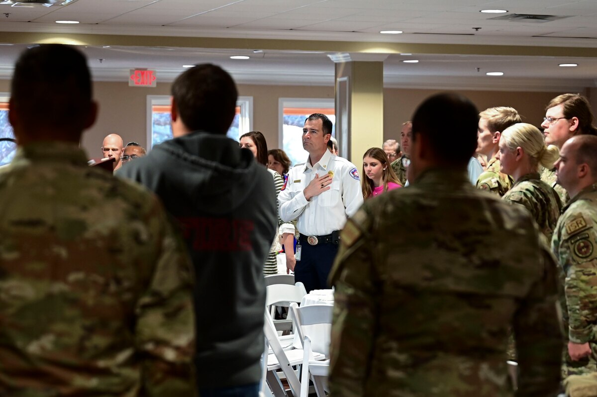 Patrick Brody, 17th Training Wing honorary commander, along with members of the 17th Training Group stand during the National Anthem while attending the 17th Training Group annual awards ceremony at the San Angelo Country Club, San Angelo, Texas, Jan. 12, 2024. The honorary commanders started their day off with the opportunity to interact and have breakfast with members of the 17th TRG. (U.S. Air Force photo by Airman 1st Class Madison Collier)
