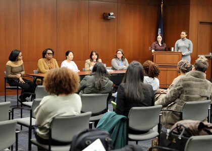 The Naval Surface Warfare Center, Philadelphia Division (NSWCPD) Women’s Employee Resource Group (WERG) Chair and Solid Waste and Hazardous Materials In-Service Engineering Branch Manager Allyson Jones-Zaroff (podium, left) and African American Employee Resource Group (AAERG) Secretary and Mechanical Engineer Taylor Barnett (podium, right) moderate the command’s Women’s Leadership Panel for a hybrid audience on Nov. 29, 2023. Panel members included (from left to right): Deputy Human Resource Director Keirston Graves; Comptroller Department Head Joyce Hall; Platforms Division Surface Ship Maintenance, Modernization and Sustainment (SEA21) Portfolio Manager Mia Korngruen; Propulsion, Power and Auxiliary Machinery Systems Department Head Karen Dunlevy-Miller; and Submarine Life Support R&D Lead Jay Smith. (U.S. Navy Photo by Phil Scaringi/Released)