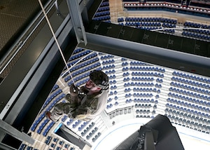 U.S. Air Force Staff Sgt. Ian Simonsen, a pararescueman of the 106th Rescue Wing, F.S. Gabreski Air National Guard Base, Westhampton Beach, New York Air National Guard, rappels onto the ice for the New York Islanders game at the UBS Arena in Elmont, New York, November 11, 2023.