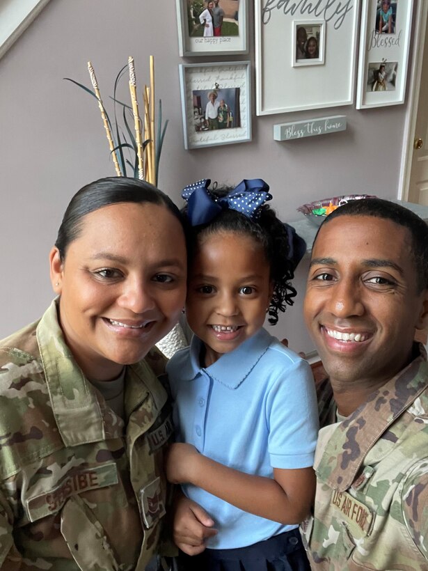 Tech. Sgt. Theodore Sebsibe, right, spends time with his wife and daughter.