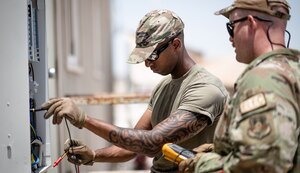 U.S. Air Force Tech. Sgt. Theodore Sebsibe does electrical work during a deployment to Al Udeid Air Base, Qatar, in 2023.
