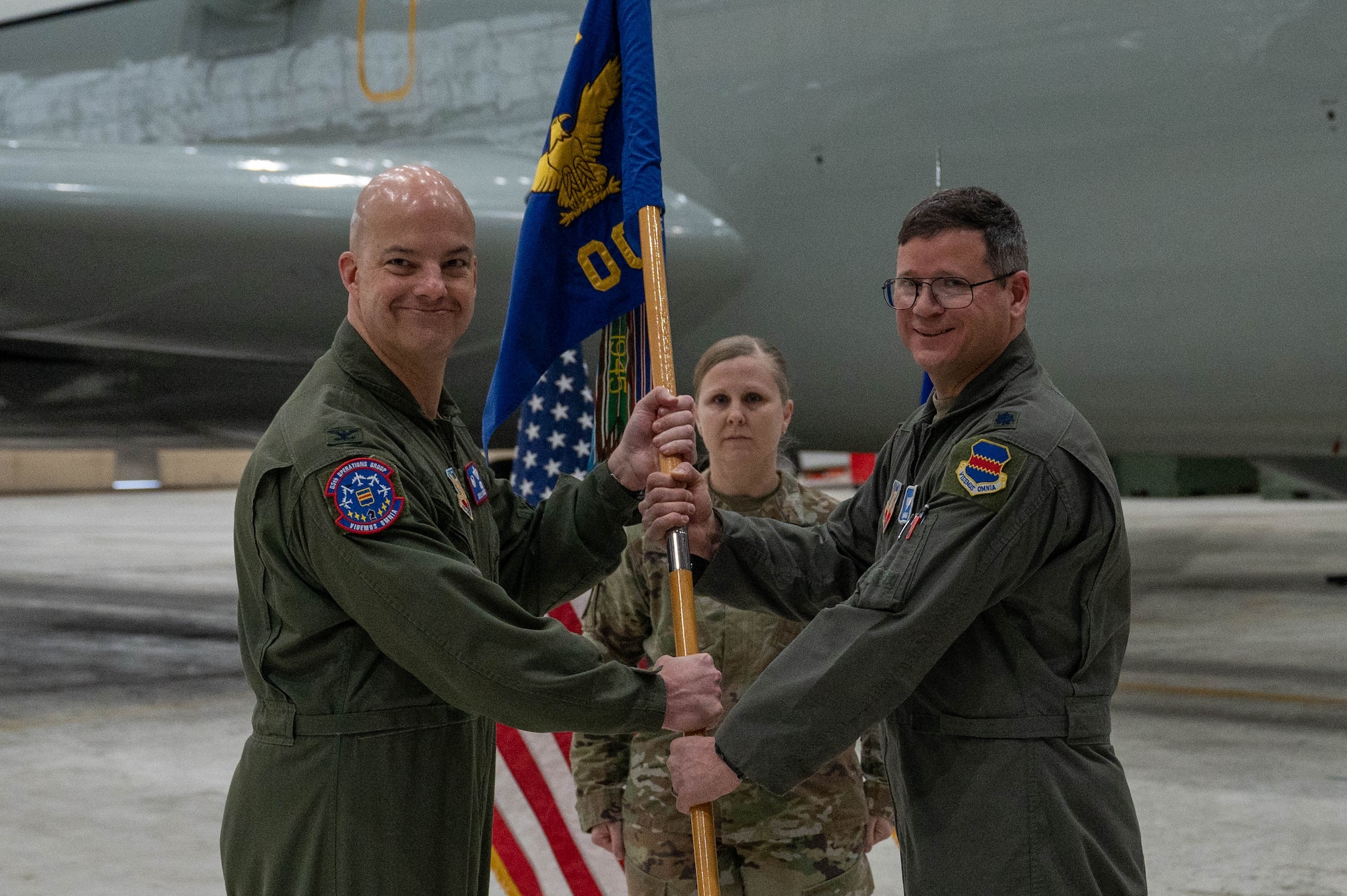 Airmen pass a guidon during an assumption-of-command ceremony.