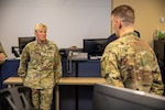 U.S. Army 1st Lt. Joel Belles, operations officer, Bravo Crew, 100th Missile Defense Brigade, Colorado Army National Guard, briefs U.S. Army Brig. Gen. Laura Clellan, the adjutant general of Colorado, about his operational duties at Schriever Space Force Base, Colorado Springs, Colorado, Dec. 7, 2023. Each crew consists of five members and crews who defend the homeland with ground-based midcourse defense systems 24/7/365. (U.S. Army National Guard photo by Staff Sgt. Taylor Lakey-Tamacori)