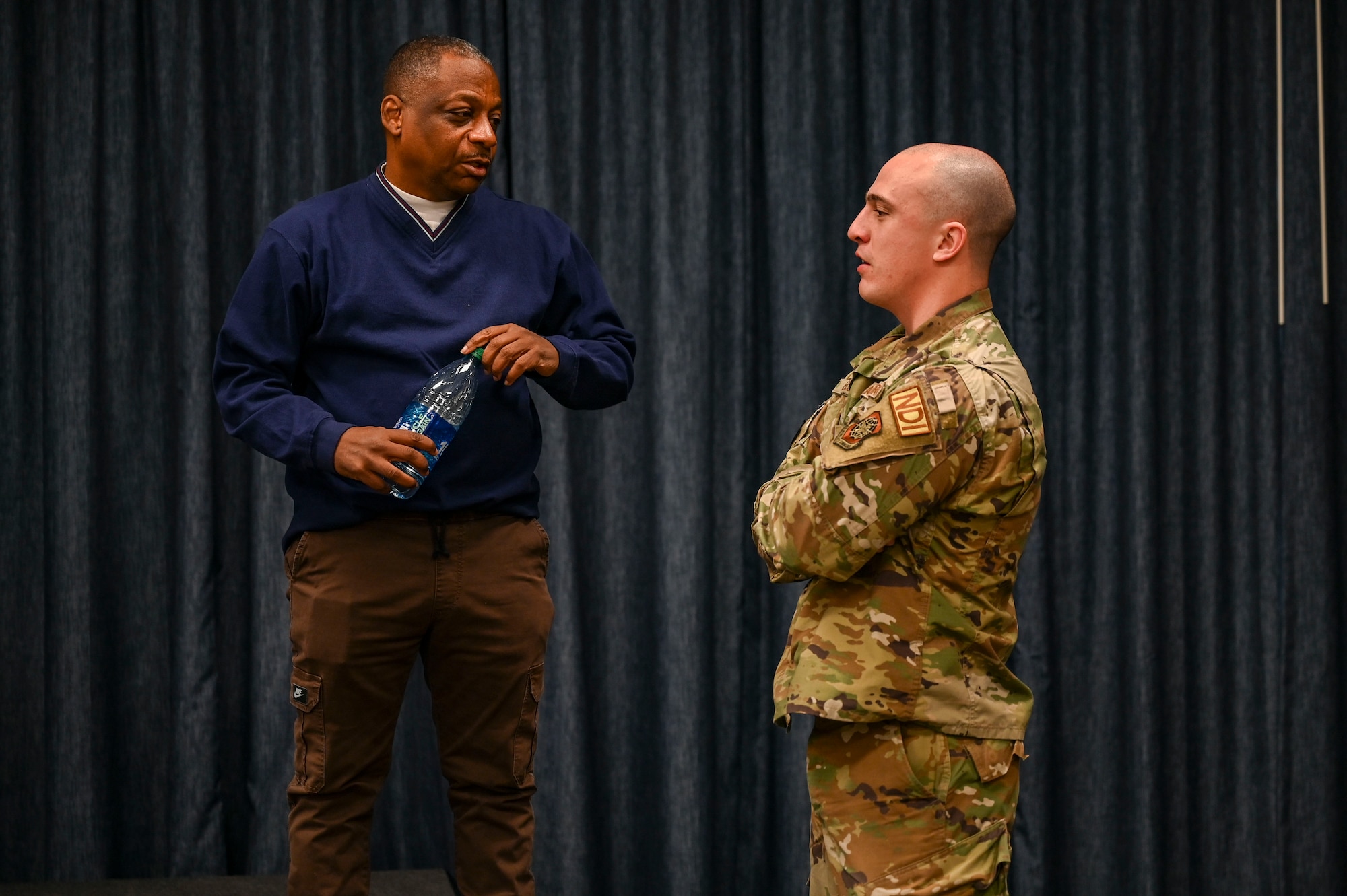 Guest speakers speaks with an Airman