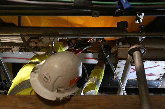 A member in support of Joint Task Force-Red Hill (JTF-RH) secures a drainage line underneath a spectacle blind to remove residual fuel from the Red Hill Bulk Fuel Storage Facility Jan. 18, 2024, Halawa, Hawaii.
