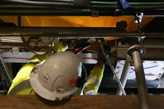 A member in support of Joint Task Force-Red Hill (JTF-RH) secures a drainage line underneath a spectacle blind to remove residual fuel from the Red Hill Bulk Fuel Storage Facility Jan. 18, 2024, Halawa, Hawaii.