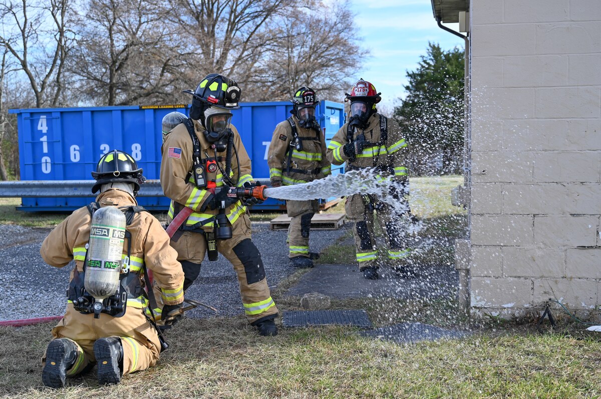 Airmen assigned to the 175th Wing Fire Department work to mitigate the risk of a simulated fire during Operation Frosty Strike Nov. 30, 2023, at Martin State Air National Guard Base, Middle River, Md.