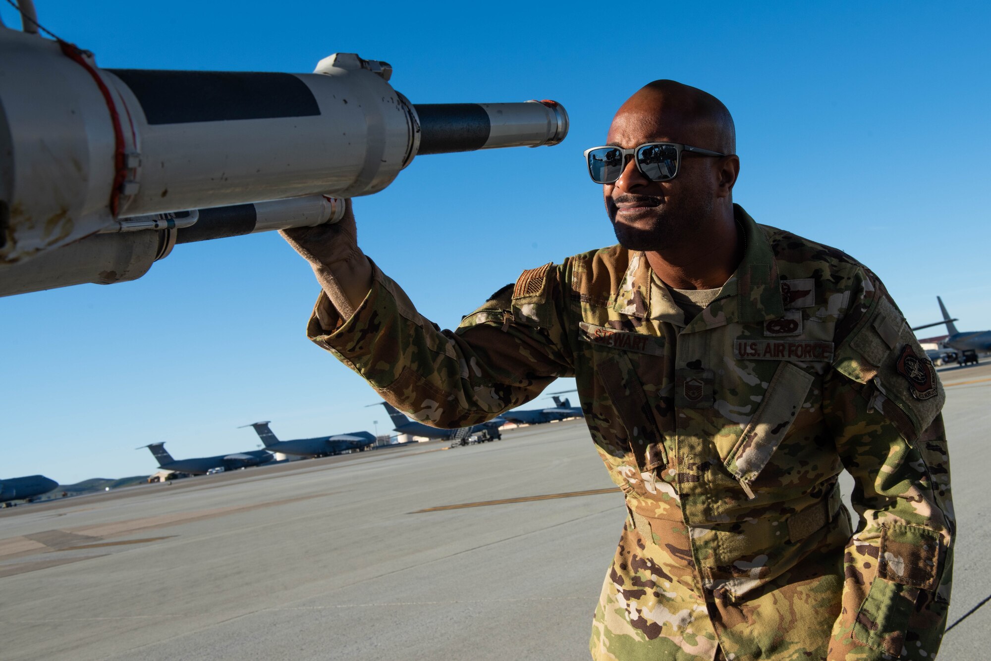 Flight engineer conducts pre-flight checks on aircraft.
