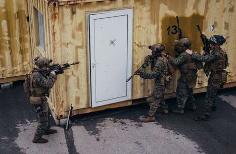 U.S. Marines with the Battalion Landing Team 1/6, 26th Marine Expeditionary Unit (MEU) (Special Operations Capable) (MEU(SOC)), prepare to breach a building during Military Operations on Urbanized Terrain training at Naval Support Activity Souda Bay, on the island of Crete, Greece, Dec. 16, 2023. U.S. Marines and Sailors of the 26th Marine Expeditionary Unit (Special Operations Capable), embarked on the ships of the Bataan Amphibious Ready Group, are on a scheduled deployment with elements deployed to the U.S. 5th Fleet and U.S. 6th Fleet areas of operation to increase maritime security and stability, and to defend U.S., Allied, and Partner interests. (U.S. Marine Corps photo by Cpl. Aziza Kamuhanda)