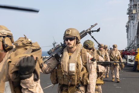 231221-M-VB101-2066 U.S. 5TH FLEET AREA OF OPERATIONS (Dec. 21, 2023) A U.S. Marine with Alpha Company, Battalion Landing Team 1/6, 26th Marine Expeditionary Unit (Special Operations Capable) (MEU(SOC)), prepares to board a CH-53E Super Stallion conducting a tactical recovery of aircraft and personnel exercise aboard amphibious assault ship USS Bataan (LHD 5), Dec. 21. Marines and Sailors of the 26th Marine Expeditionary Unit (Special Operations Capable), embarked on the ships of the Bataan Amphibious Ready Group, are on a scheduled deployment as the Tri-Geographic Combatant Command crisis response force with elements deployed to the U.S. 5th Fleet and U.S. 6th Fleet areas of operation to increase maritime security and stability, and to defend U.S., Allied, and Partner interests. (U.S. Marine Corps photo by Sgt. Matthew Romonoyske-Bean)
