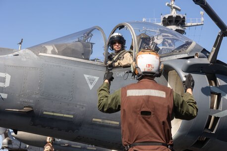 231226-M-VB101-1095 U.S. 5TH FLEET AREA OF OPERATIONS (Dec. 26, 2023) U.S. Marine Corps Capt. Earl Ehrhart V, an AV-8B Harrier pilot attached to Marine Medium Tiltrotor Squadron (VMM) 162 (Reinforced), 26th Marine Expeditionary Unit (Special Operations Capable) (MEU(SOC)), receives signals during flight operations aboard amphibious assault ship USS Bataan (LHD 5), Dec. 26. Marines and Sailors of the 26th Marine Expeditionary Unit (Special Operations Capable), embarked on the ships of the Bataan Amphibious Ready Group, are on a scheduled deployment as the Tri-Geographic Combatant Command crisis response force with elements deployed to the U.S. 5th Fleet and U.S. 6th Fleet areas of operation to increase maritime security and stability, and to defend U.S., Allied, and Partner interests. (U.S. Marine Corps photo by Sgt. Matthew Romonoyske-Bean)