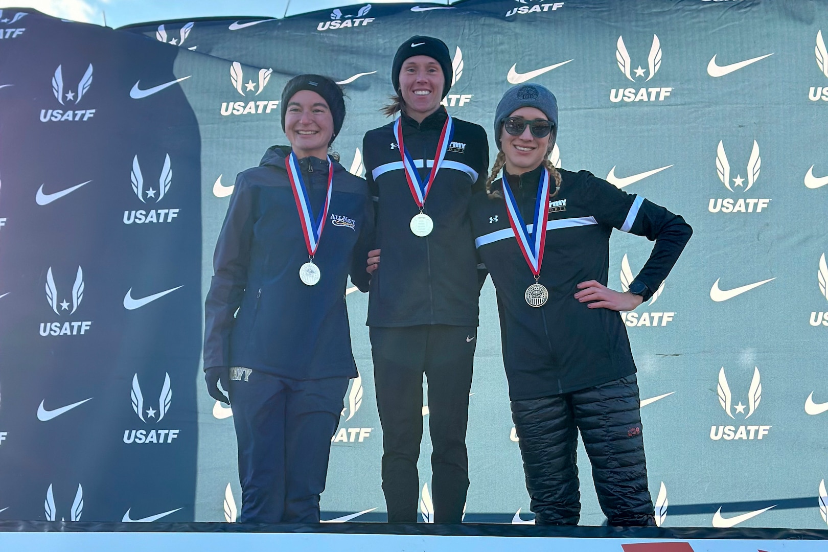 From left to right:  Navy Ensign Elizabeth Sullivan, Army Sgt. Colett Rampf, and Lt. Col. Kelly Calway willing silver, gold and bronze respectively during the 2024 Armed Forces Cross Country Championship held in conjunction with the USA Track and Field Cross Country National Championship in Richmond, Va.  The Armed Forces Championship features teams from the Army, Marine Corps, Navy (with Coast Guard runners), and Air Force (with Space Force Runners).  Department of Defense Photo by Mr. Steven Dinote - Released.