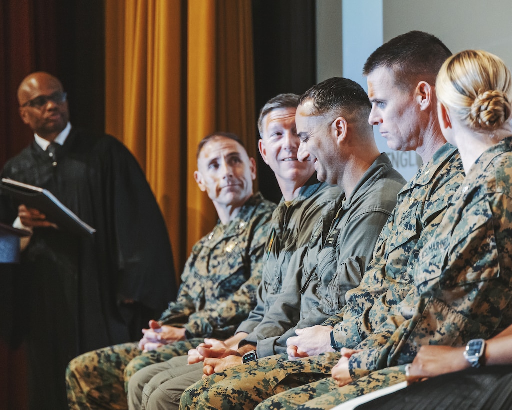 U.S. Marine Corps base leadership with Marine Corps Air Station Futenma sit in support during a Dr. Martin Luther King Jr. celebration on MCAS Futenma, Okinawa, Japan, Jan. 17, 2023. During the celebration, Marines learned about Dr. King and the political movements of his time through videos and songs addressing racial injustice and the hope for a better future. After taking a pledge to promote equal opportunity, the Marines linked arms and sang together, showing their unity and commitment to equality. (U.S. Marine Corps photo by Cpl. Jonathan Beauchamp)