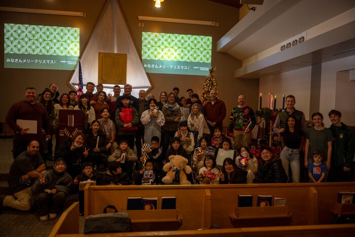 Members and volunteers of the Misawa Air Base Chapel and the Biko-en Children's Care Facility pose for a photo during an Orphanage Angel Tree Gifts and Pool Party at Misawa Air Base, Japan, Dec. 16, 2023.