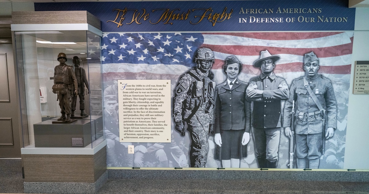 A graphic depicting African Americans who have served in the military is shown on a panel of the exhibit at the Pentagon.