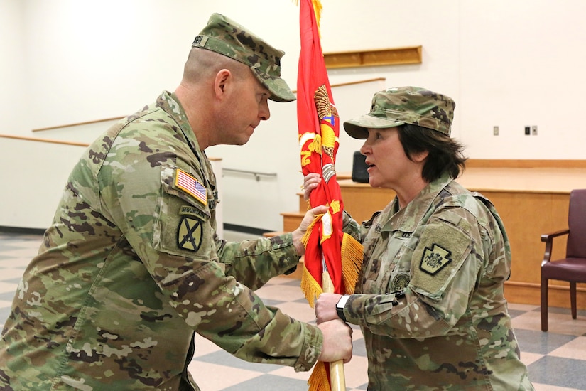 U.S. Army Col. Robert C. Jorgensen Jr., outgoing commander of the 166th Regiment - Regional Training Institute, passes the regimental flag to Brig. Gen. Laura A. McHugh, deputy adjutant general – Army, Pennsylvania National Guard during the regiment's change of command ceremony at Fort Indiantown Gap, Annville, Pa. Jan. 19, 2024.