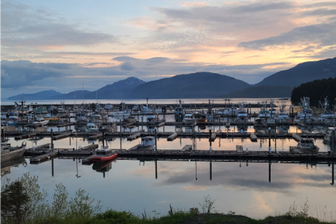 Boats resting at sunset in a harbor.