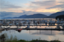 Boats resting at sunset in a harbor.