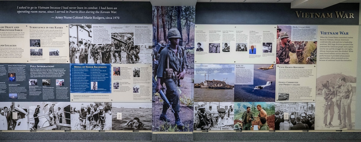 An infographic wall display depicts African Americans in the Vietnam War with pictures and text.