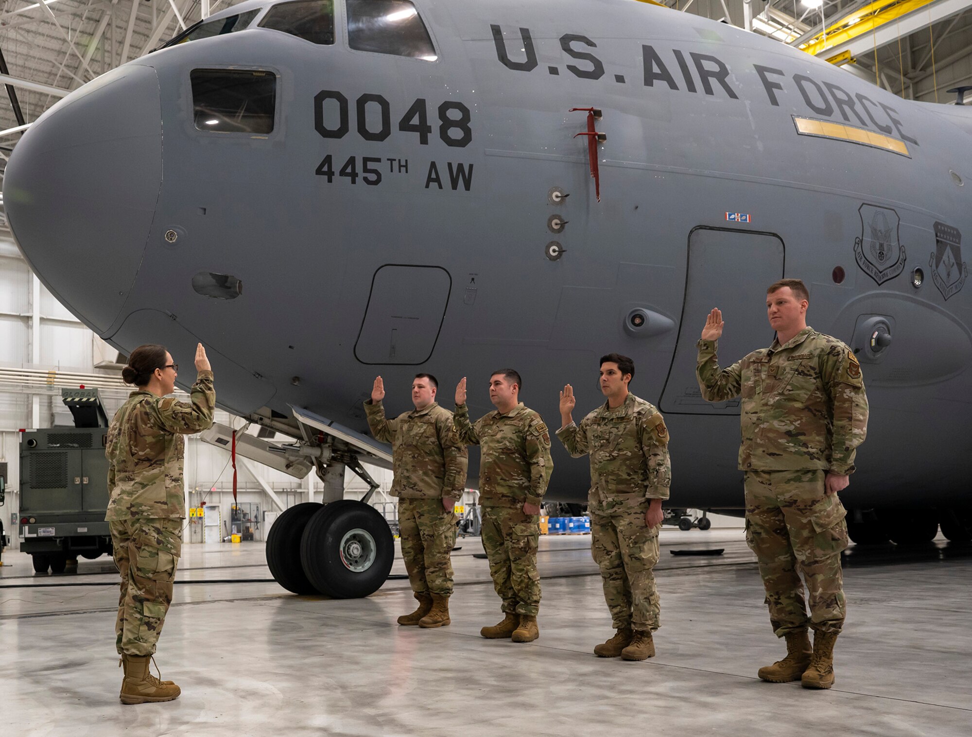 Reserve Citizen Airmen from the 445th Maintenance Squadron are sworn in by Lt. Col. Karen Gharst, 445th Maintenance Squadron Group deputy commander, during a mass re-enlistment ceremony performed next to a C-17 Globemaster III Jan. 7, 2024. 

The participants’ age and time in varied and all wanted to continue their military service.