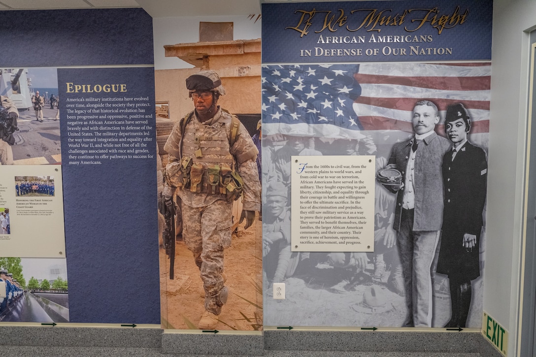 A full-scale wall graphic with text and photos shows African Americans who served in the military.