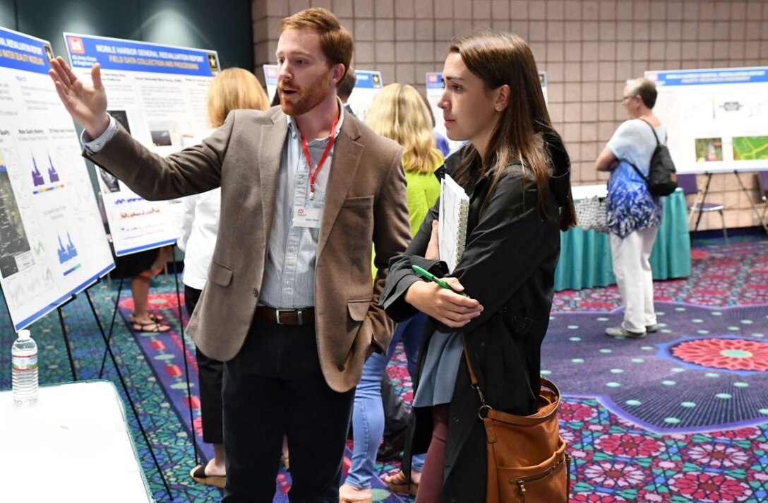 John Bass, Senior Engineering Technical Lead for Civil Works with the U.S. Army Corps of Engineers Mobile District, spoke with a community member at the Open House hosted by the Corps September 11, 2018, at the Mobile Convention Center in Mobile, Ala. The open house was to explain and to receive public comment on the Mobile Harbor Draft General Reevaluation Report with Supplemental Environmental Impact Statement. (Photo by Charles Walker U.S. Army Corps of Engineers)