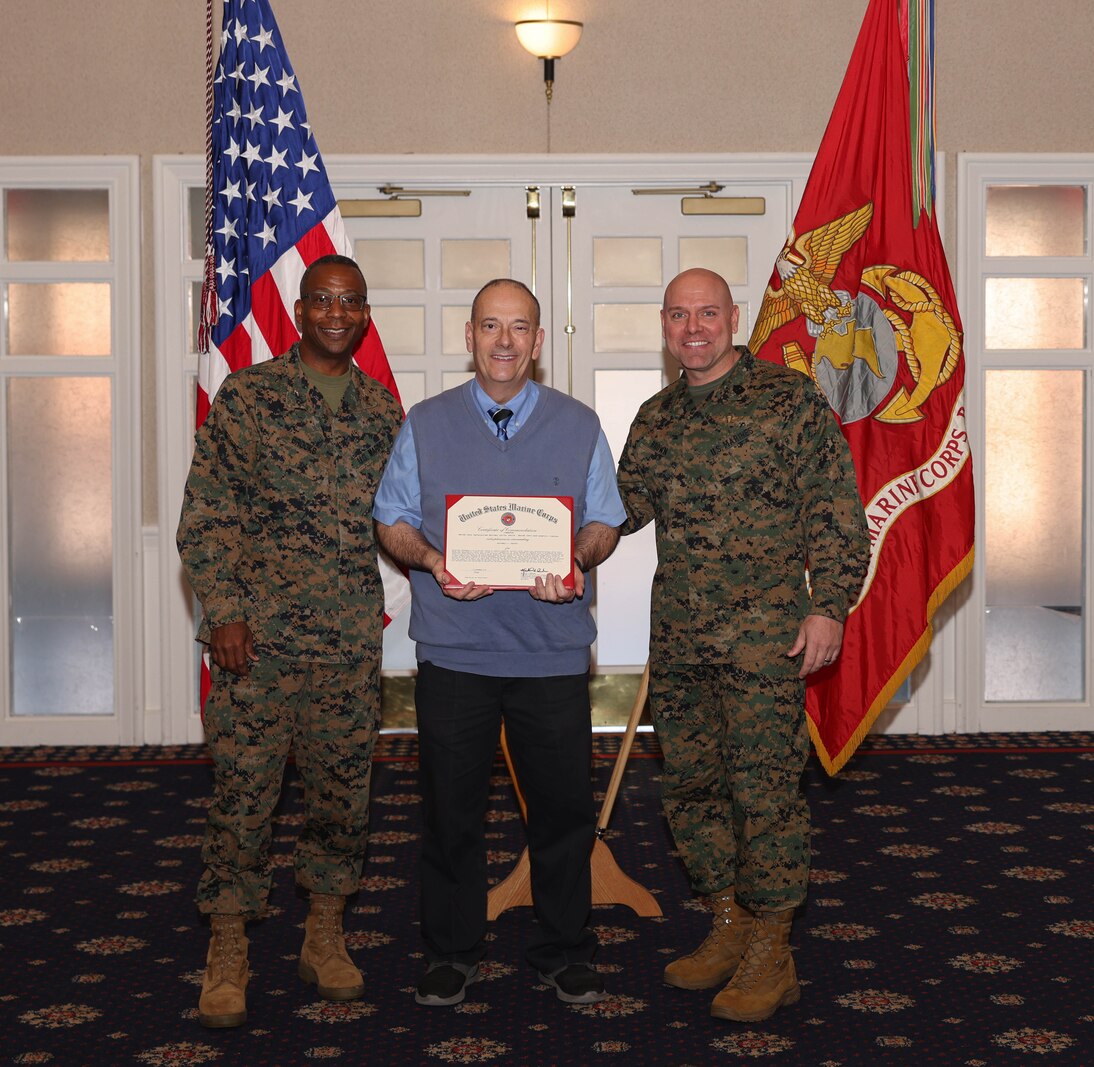 Mitchell V. Krauss, a financial technician with the Chaplain’s Office, poses with U.S. Marine Corps Col. Michael L. Brooks, a South Boston, Virginia, native and base commander, Marine Corps Base Quantico, left, and Sgt. Maj. Michael R. Brown, a Jacksonville, Florida, native and sergeant major, MCINCR-MCBQ, during the Civilian Quarterly Awards at The Clubs at Quantico, MCINCR-MCBQ, Virginia, Jan. 11, 2024. Krauss was recognized with the Junior Appropriated Fund Personnel Civilian Employee of the Quarter Award for work done in the 4th quarter of 2023. (U.S. Marine Corps photo by Lance Cpl. David Brandes)