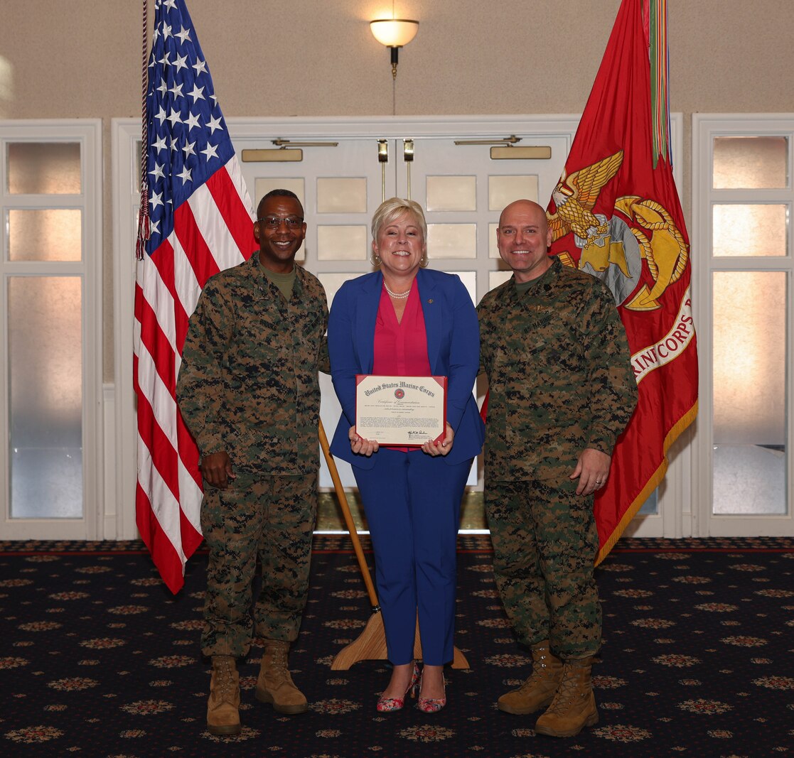 Carrie Elizabeth Jackson, a manpower management specialist with G-1 Division, poses with U.S. Marine Corps Col. Michael L. Brooks, a South Boston, Virginia, native and base commander, Marine Corps Base Quantico, and Sgt. Maj. Michael R. Brown, a Jacksonville, Florida, native and sergeant major, MCINCR-MCBQ, the Civilian Quarterly Awards at The Clubs at Quantico, MCINCR-MCBQ, Virginia, Jan. 11, 2024. Jackson was recognized with the Junior Appropriated Fund Personnel Civilian Employee of the Year Award for work done in 2023.  (U.S. Marine Corps photo by Lance Cpl. David Brandes)