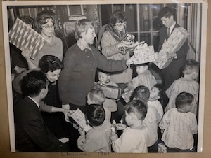 A photo of children receiving presents during a gift drive organized by Misawa Air Base in 1961, is held in a scrapbook at the Biko-en Children's Care Facility, Japan, Jan. 16, 2024.
