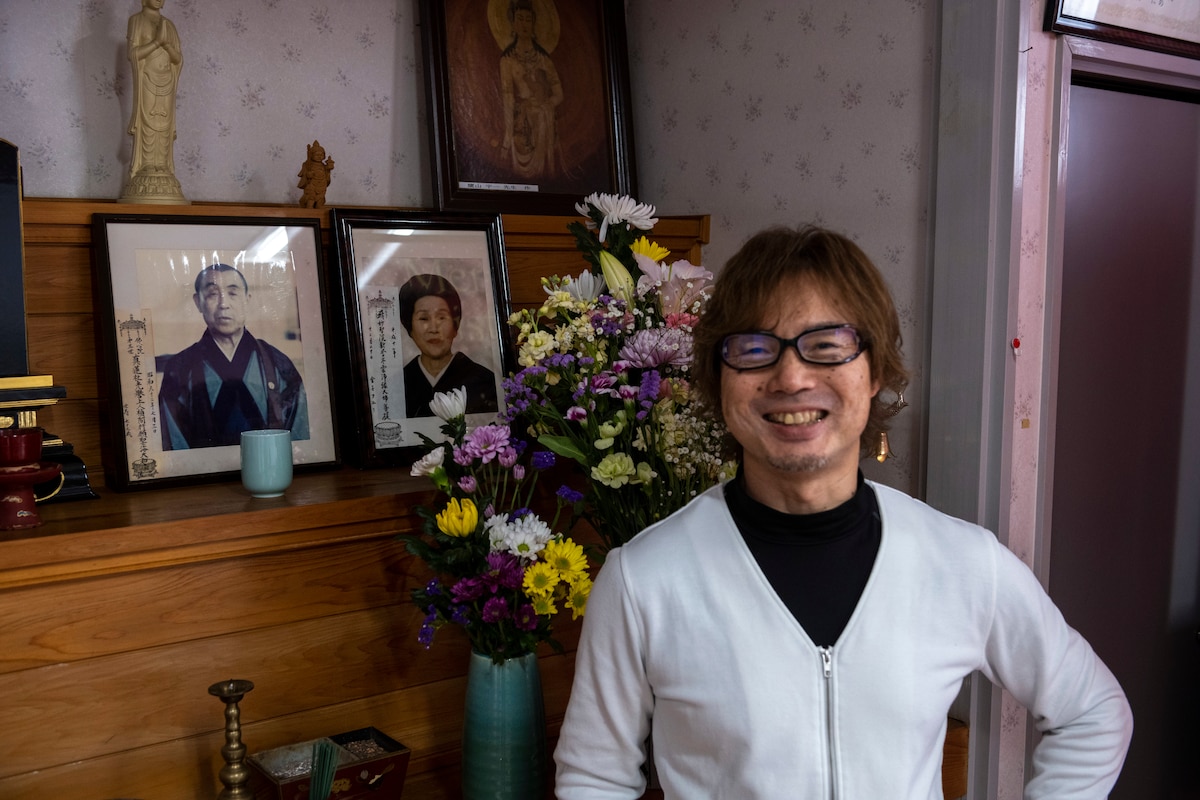 Mr. Tatsuya Goto, Biko-en Children's Care Facility director, stands in front of a photo of the founder of the orphanage in Shichinohe, Japan, Dec. 20, 2023.