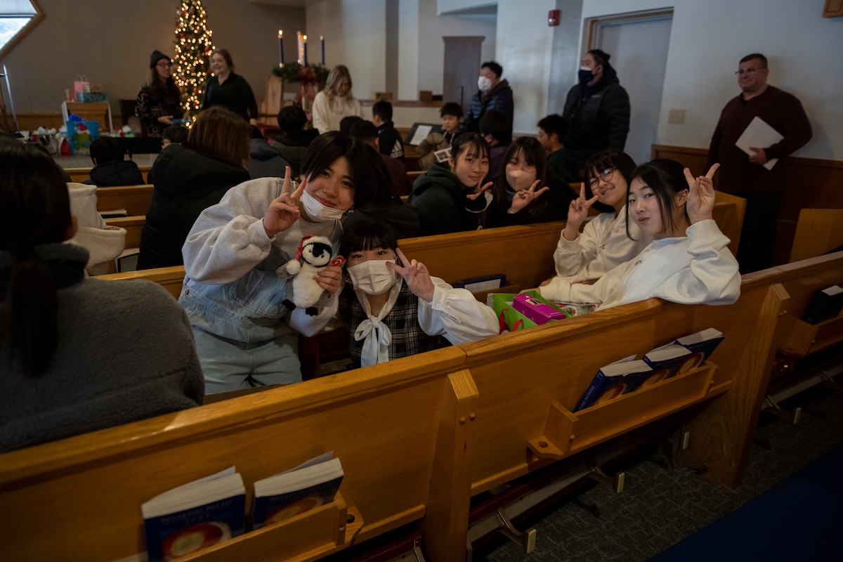 Youths of the Biko-en Children's Care Facility show off their gifts during an Orphanage Angel Tree Gifts and Pool Party at Misawa Air Base, Japan, Dec. 16, 2023.