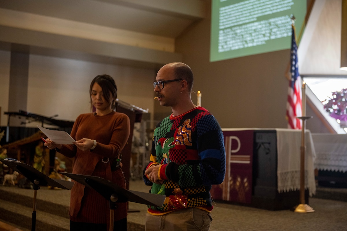 U.S. Air Force 1st Lt. Evan Murray, Angel Tree Gift volunteer, reads off a Biblical account of the Christmas story during an Orphanage Angel Tree Gifts and Pool Party at Misawa Air Base, Japan, Dec. 16, 2023.