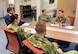 group of men and women seated at a table in a discussion