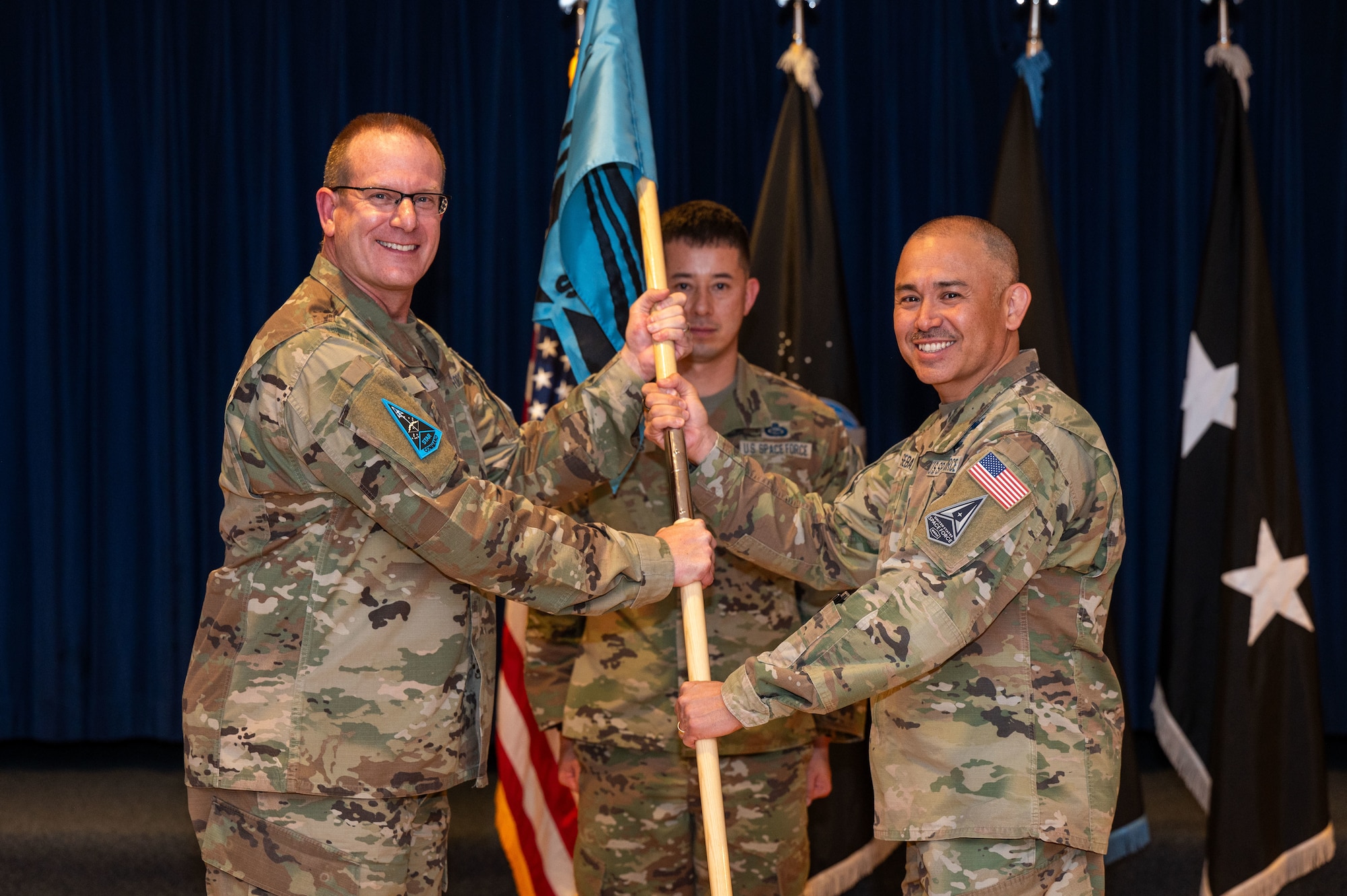 U.S. Space Force Chief Master Sgt. James Seballes presents the unit guidon to Maj. Gen. Timothy Sejba, commander of Space Training and Readiness Command, during a change of responsibility ceremony at Peterson Space Force Base, Colorado, Jan. 19, 2024. During the ceremony, Chief Master Sgt. Karmann-Monique Pogue succeeded Seballes as the second senior enlisted leader of STARCOM. (U.S. Space Force photo by Ethan Johnson)