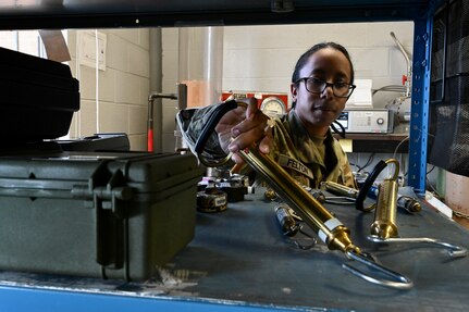 Spc. Jasmine Felton, a District of Columbia National Guard electronics and calibration technician within the Test Measurement Diagnostic Equipment (TMDE) section, inventories mechanical tube scales at the Surface Equipment Maintenance Facilities/Combined Support Maintenance Shop at Joint Base Anacostia-Bolling, Jan. 18, 2024. Standardized measurements ensure weapons systems from aircraft to mission-critical vehicles operate safely and effectively.