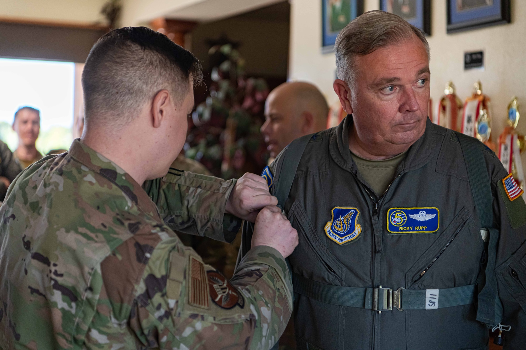 Lt. Gen. Ricky Rupp makes pre-flight preparations with a 18th OSS service member.