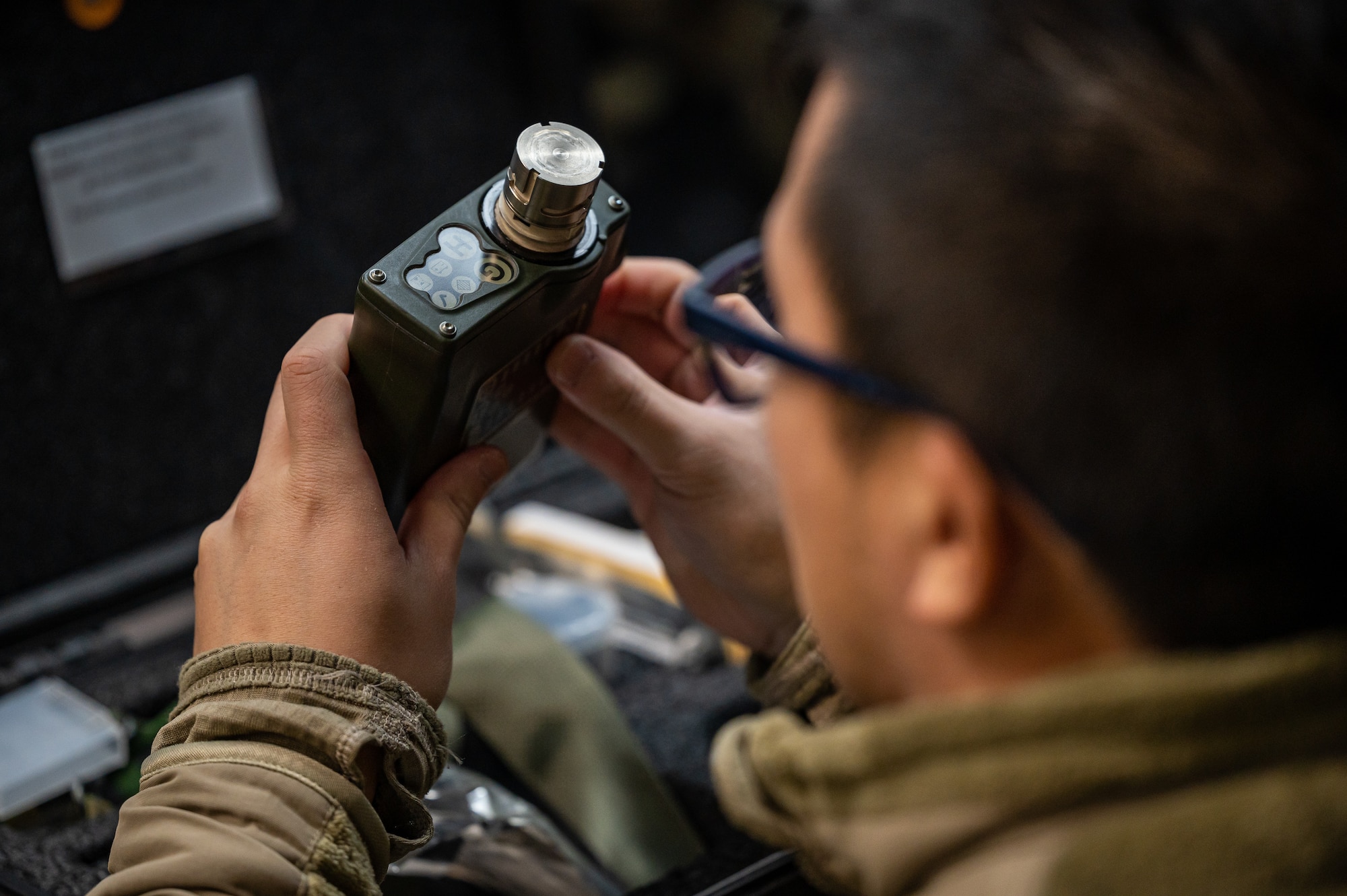 U.S. Air Force Airman 1st Class Raymond Khoo, 51st Munitions Squadron munitions technician, examines a Joint Chemical Agent Detector during Shelter Management Training at Osan Air Base, Republic of Korea, Jan. 17, 2024. Training to operate a JCAD is a requirement for shelter managers and assistants and is used to ensure that Airmen are safe by alerting operators of the presence of nerve and blister vapors, as well as one blood chemical agent and one toxic industrial chemical vapor. (U.S. Air Force photo by Staff Sgt. Thomas Sjoberg)
