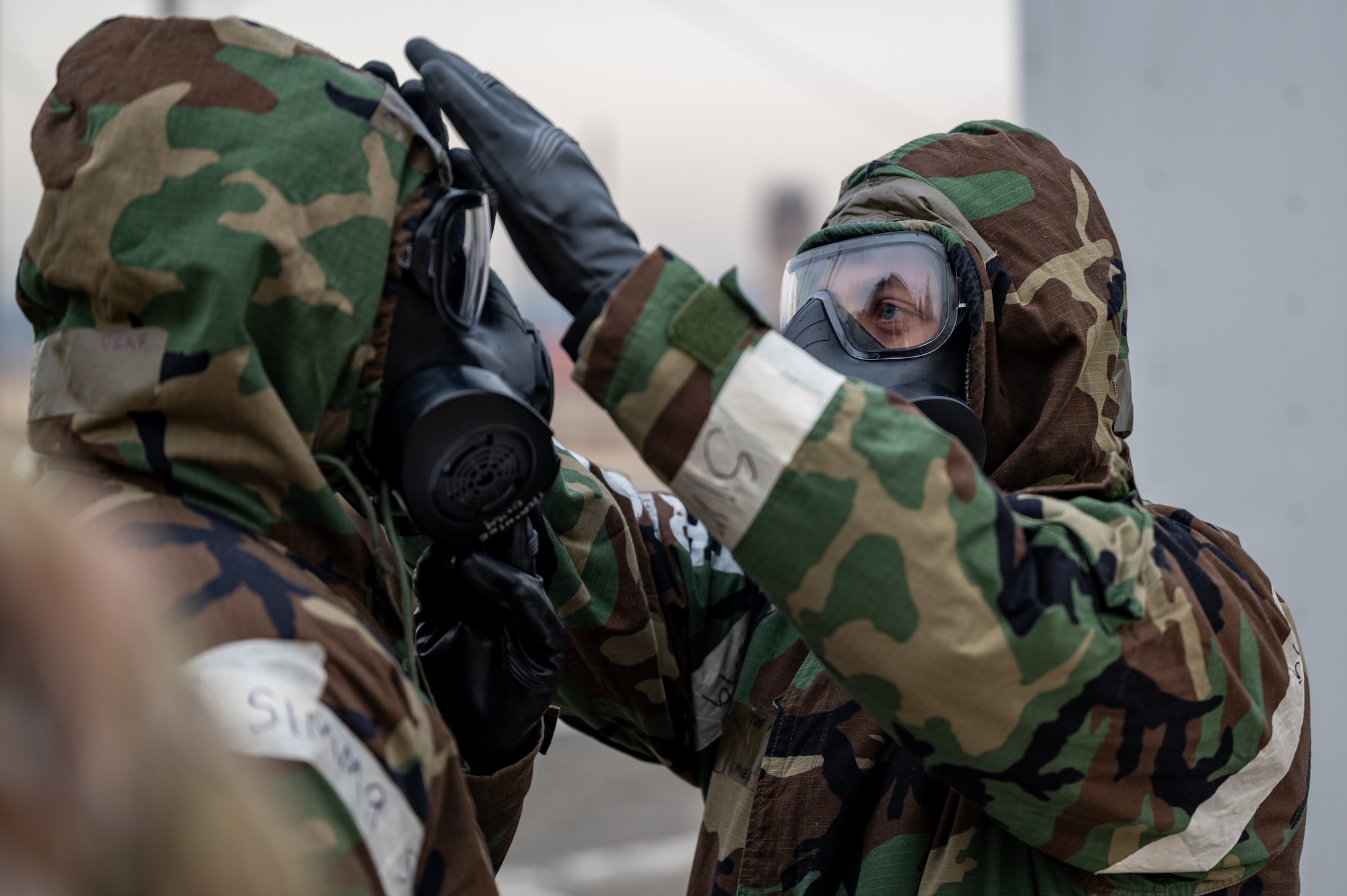 U.S. Air Force Airman 1st Class Rafe Russell, 51st Communications Squadron radio frequency technician, left, and Airman 1st Class Chase Verzaal, 51st Fighter Wing public affairs apprentice, simulate decontamination procedures during Shelter Management Training at Osan Air Base, Republic of Korea, Jan. 17, 2024. Training on responsibilities like managing protective facilities creates multi-capable Airmen and enhances the 51st FW’s ability to carry out the “Fight Tonight” mission. (U.S. Air Force photo by Staff Sgt. Thomas Sjoberg)