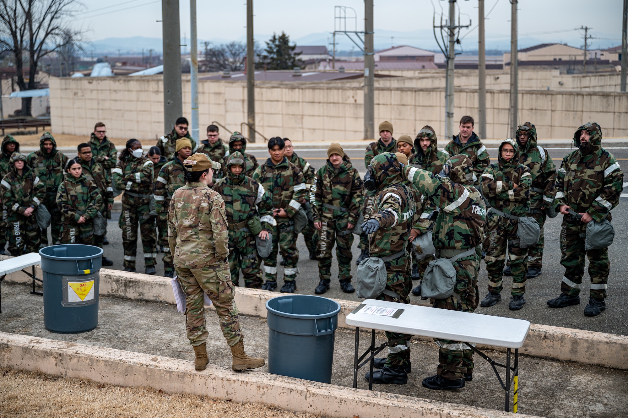 U.S. Air Force Airman 1st Class Kylah Deroche, 51st Civil Engineer Squadron emergency management apprentice, briefs Airmen on the steps for decontamination during Shelter Management Training at Osan Air Base, Republic of Korea, Jan. 17, 2024. Airmen participating in SMT are responsible for ensuring the safety of base facilities. Their duties include acting as a shelter manager or assistant, where they oversee and maintain the integrity and security of shelters. (U.S. Air Force photo by Staff Sgt. Thomas Sjoberg)