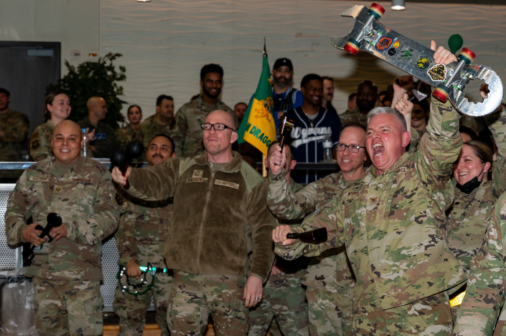Members of the 51st Maintenance Group cheer during the 51st Fighter Wing quarterly awards ceremony at Osan Air Base, Republic of Korea, Jan. 19, 2024. Quarterly awards aim to recognize top performers across the installation. (U.S. Air Force photo by Airman 1st Class Chase Verzaal)