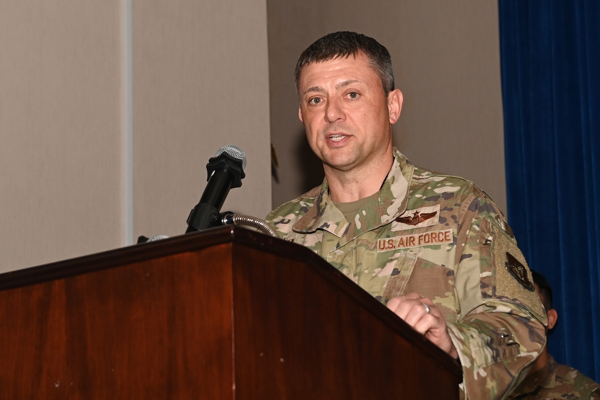 Col. Tanner Woolsey, 607th Air Operations Center incoming commander, speaks at an assumption of command ceremony at Osan Air Base, Republic of Korea, Jan. 11, 2024.
