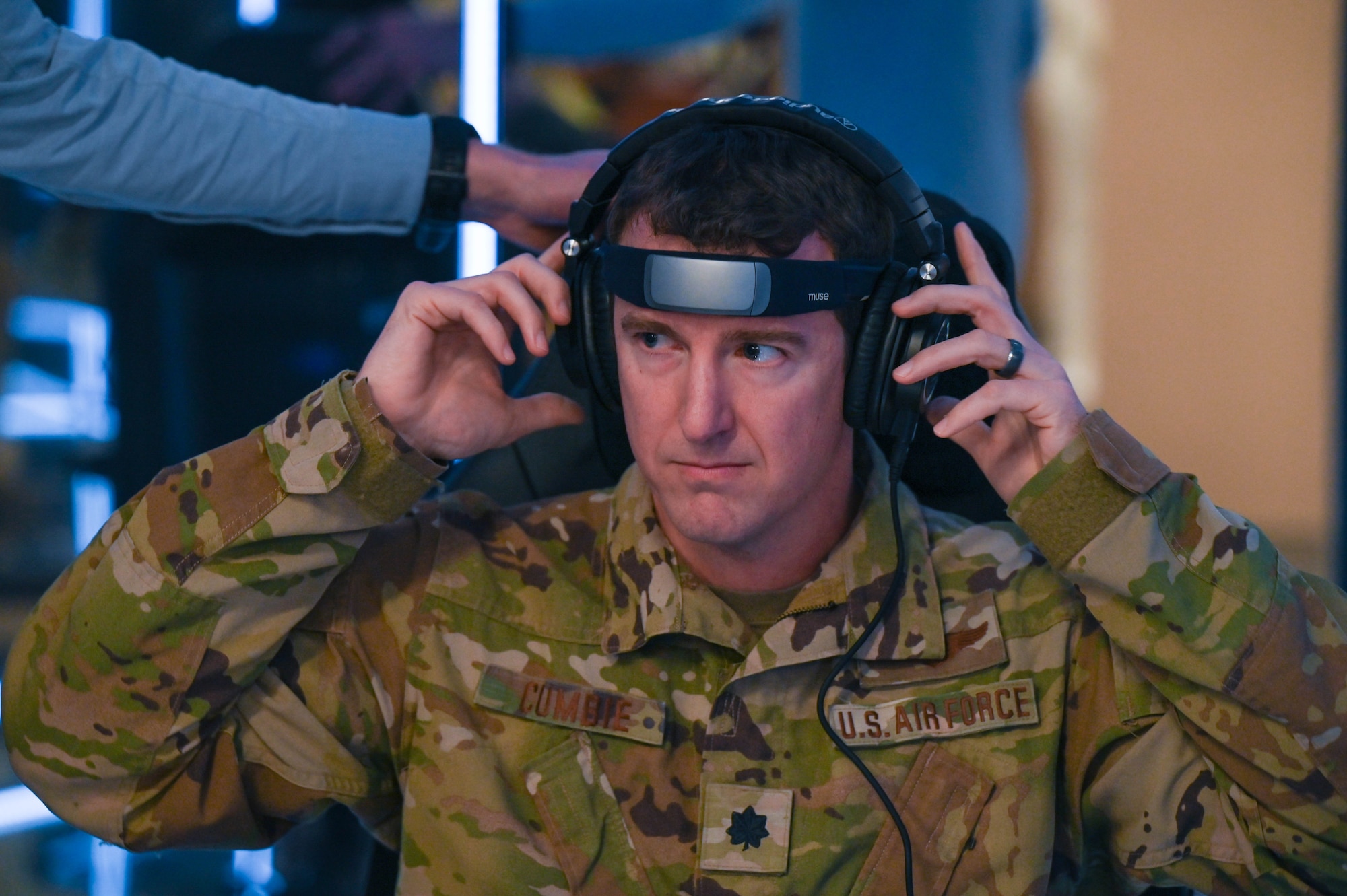 Lt. Col. Derek Cumbie putting on headphones to enter the Lumena MindGym in the Air University Library at Maxwell Air Force Base, Alabama, January 19, 2024. The MindGym creates a sensory deprivation, bio-responsive mindfulness environment, providing those with base access an additional tool to build resiliency and improve mental health. (U.S. Air Force photo by Airman 1st Class Tyrique Barquet)