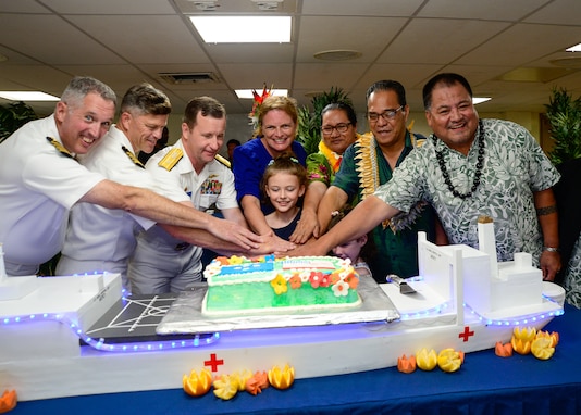 U.S. Navy Capt. Brian Quin, Pacific Partnership 2024-1 mission commander, left, U.S. Navy Capt. Jeffrey Feinberg, commanding officer of the hospital ship USNS Mercy (T-AH 19), U.S. Navy Rear Adm. Mark Melson,  commander of Task Force 73, The Honorable Jennifer Johnson, U.S. Ambassador to the Federated States of Micronesia, and daughters, His Excellency Wesley Simina, President of the Federated States of Micronesia, and The Honorable Alexander Narruhn, Chuuk State Governor, right, cut a cake during the Chuuk closing ceremony aboard the hospital ship USNS Mercy (T-AH 19), anchored off Chuuk, Federated States of Micronesia, as part of Pacific Partnership 2024-1, Jan. 20, 2024. Pacific Partnership, now in its 19th iteration, is the largest multinational humanitarian assistance and disaster relief preparedness mission conducted in the Indo-Pacific and works to enhance regional interoperability and disaster response capabilities, increase security stability in the region, and foster new and enduring friendships. (U.S. Navy photo by Mass Communication Specialist 2nd Class Celia Martin)